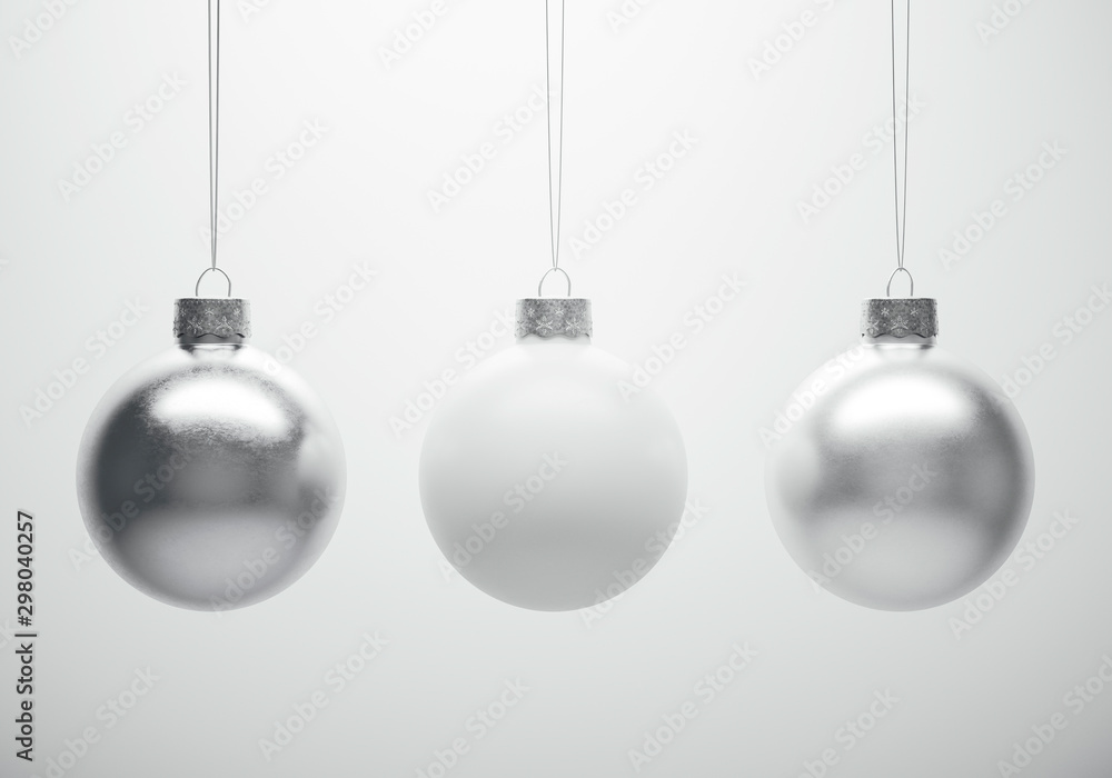 Glossy metallic christmas baubles hanging in front of white background. - obrazy, fototapety, plakaty 
