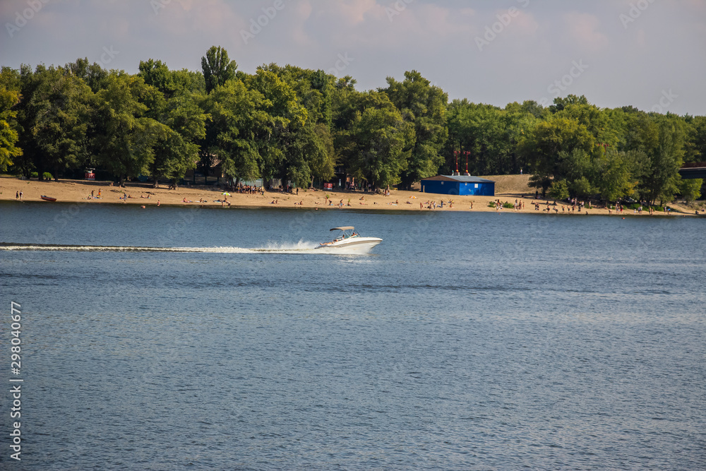 Obraz premium Tour of Kiev in the center of Europe. View of the Dnieper, Trukhanov island and a foot bridge. Park fountain and sunset on the horizon..