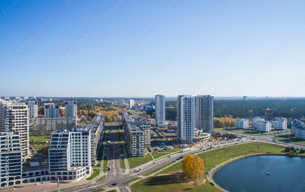 City architectural landscape Minsk. Office buildings of the road and parks. View from the roof with blue sky.