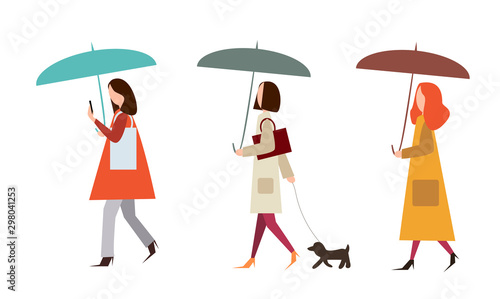 A collection of young stylish girls in bright clothes walk under umbrellas