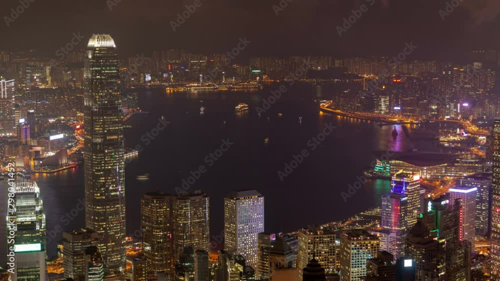 Timelapse buildings of Hong Kong city with flashing multicoloured illumination surround wide harbor with sailing boats at night zoom out on June 10 in Hong Kong Timelapse buildings of Hong Kong city with flashing multicoloured illumination surround wide harbor with sailing boats at night zoom out on June 10 in Hong Kong
