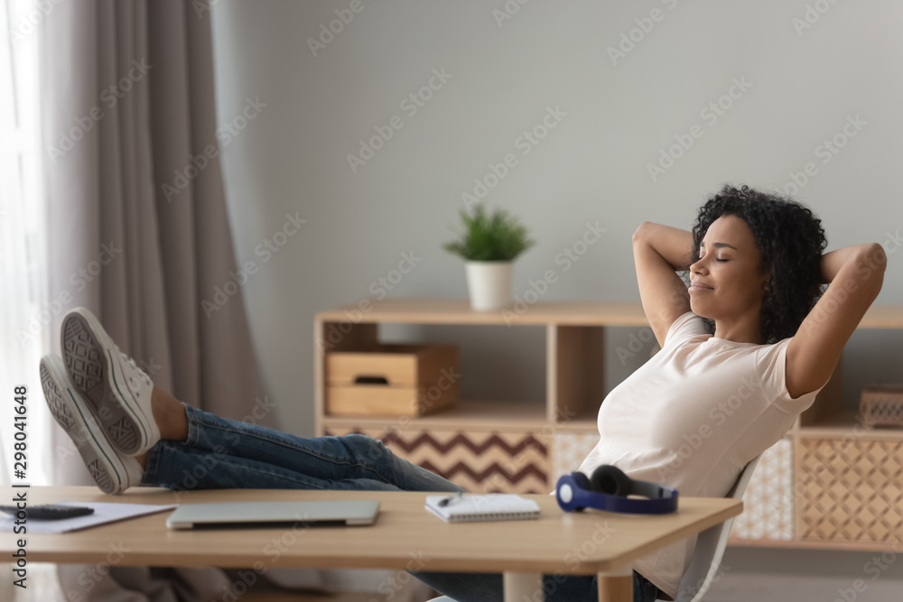 Happy black woman relax in chair at desk at home Happy black woman relax in chair at desk at home