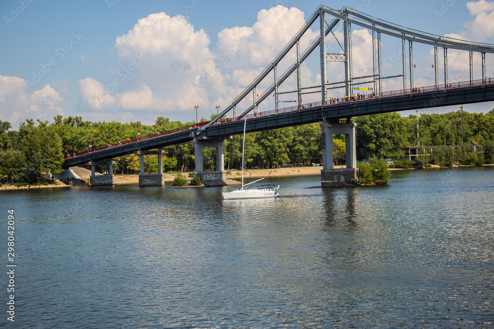 Tour of Kiev in the center of Europe. View of the Dnieper, Trukhanov island and a foot bridge. Park fountain and sunset on the horizon.. Tour of Kiev in the center of Europe. View of the Dnieper, Trukhanov island and a foot bridge. Park fountain and sunset on the horizon..