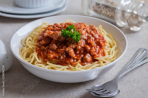 Spaghetti bolognese in white bowl