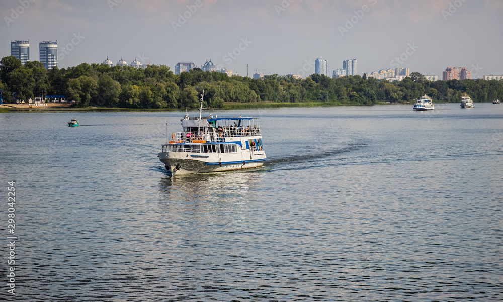 Tour of Kiev in the center of Europe. View of the Dnieper, Trukhanov island and a foot bridge. Park fountain and sunset on the horizon..