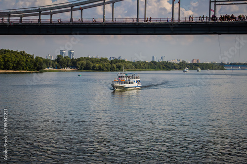 Tour of Kiev in the center of Europe. View of the Dnieper, Trukhanov island and a foot bridge. Park fountain and sunset on the horizon.. photo