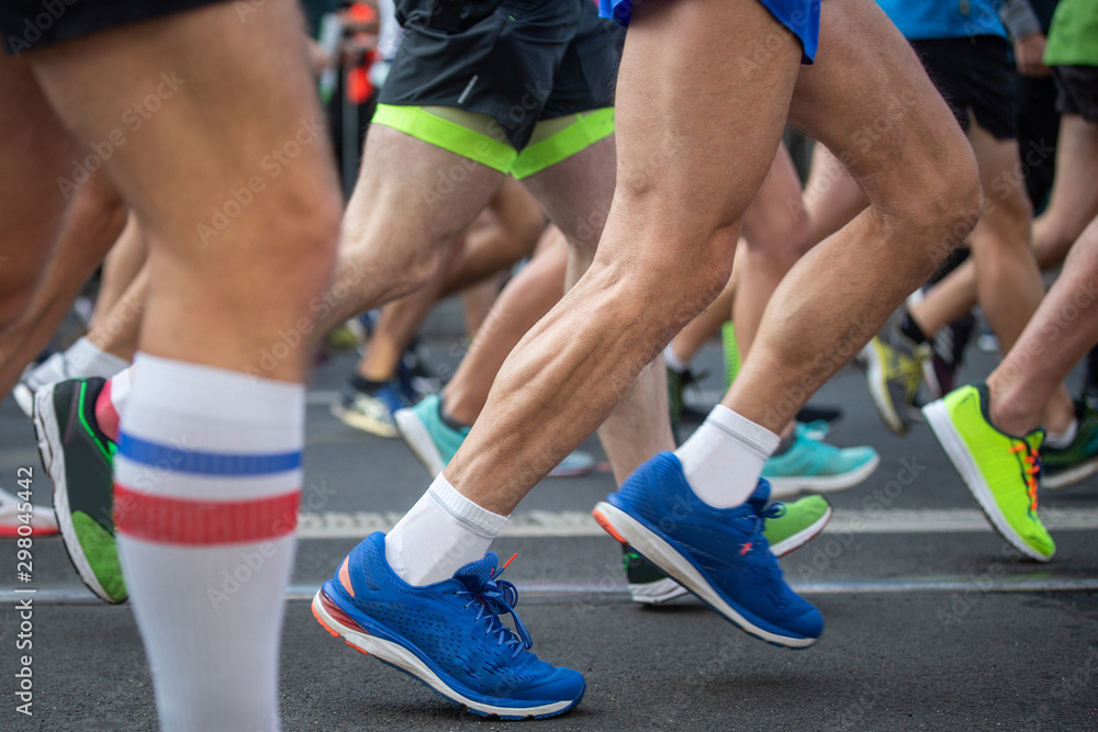 Marathon runners, running on the city road. Marathon runners, running on the city road.