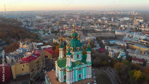 Aerial view of St. Andrews Church in Kiev. Aerial view of St. Andrew's Church at sunset, historical center, Podolsky district, Kyiv, Ukraine. A drone camera flies around the domes of St. Andrew. photo