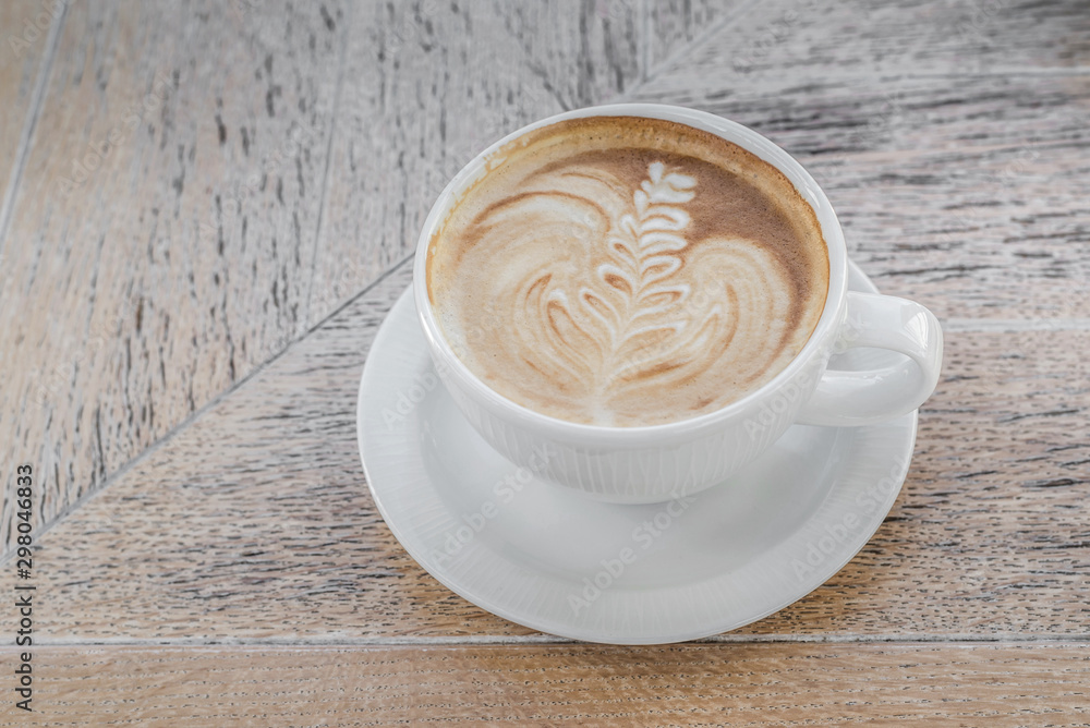White big cup of delicious coffee with art on wooden table with copy space. White big cup of delicious coffee with art on wooden table with copy space.