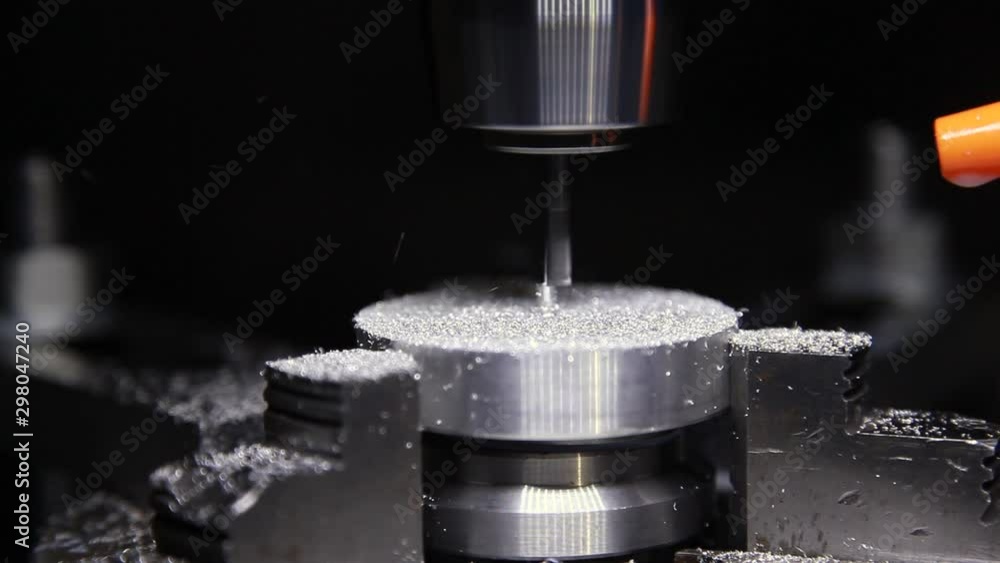 A modern metal processing machine grinds a small metal part. Special metal-cutting machines perform processing of workpieces by exposing them to a mill, which constantly rotates. A modern metal processing machine grinds a small metal part. Special metal-cutting machines perform processing of workpieces by exposing them to a mill, which constantly rotates.