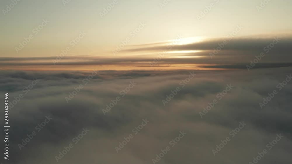 Aerial shot above clouds at dusk with incredible cloud movement Aerial shot above clouds at dusk with incredible cloud movement