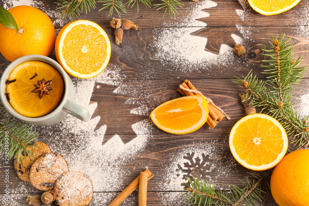 Christmas composition with fresh oranges and tea on wooden background Christmas composition with fresh oranges and tea on wooden background
