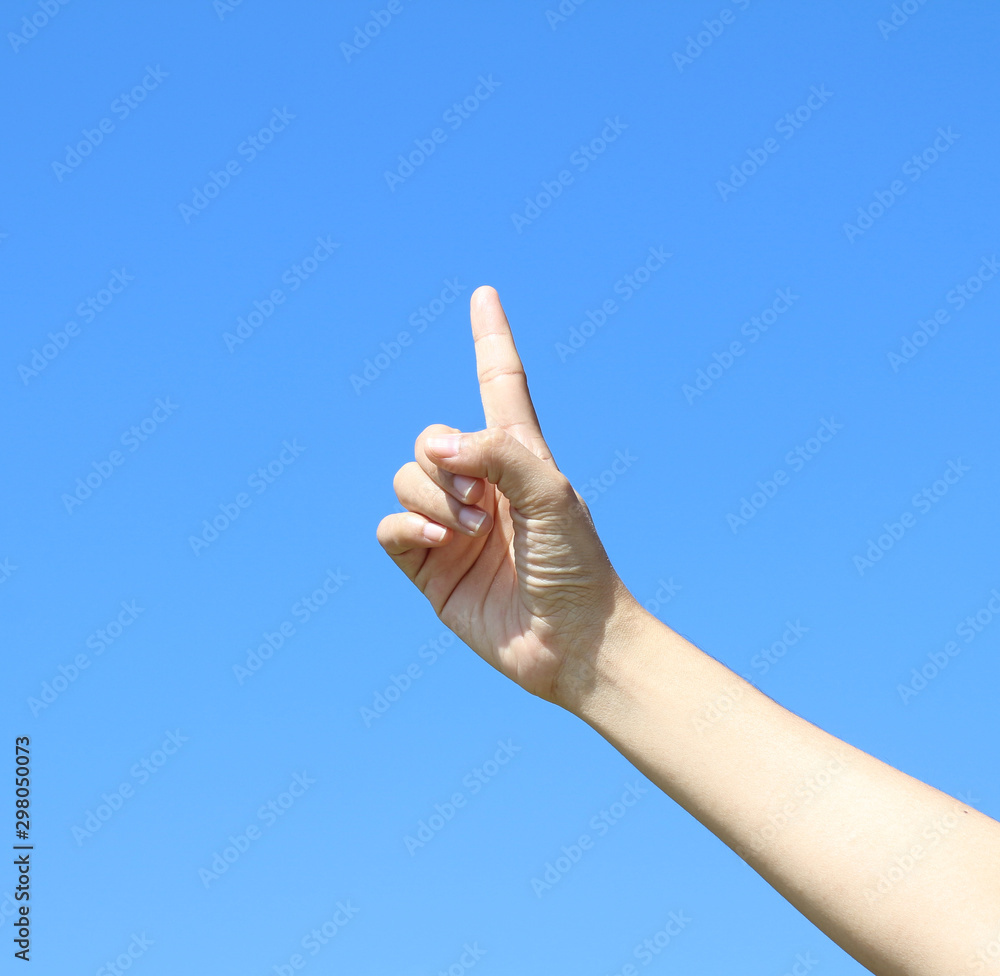 woman hand on blue sky background woman hand on blue sky background
