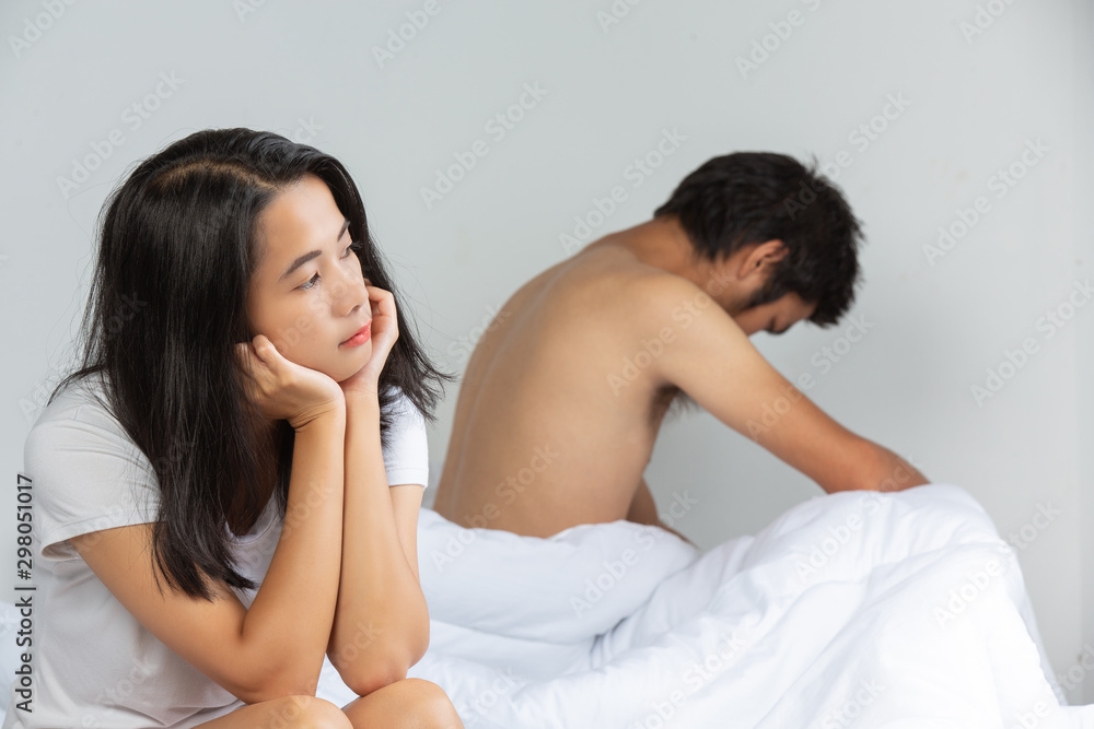 The young woman is worried and there is a man beside the white bed. The young woman is worried and there is a man beside the white bed.