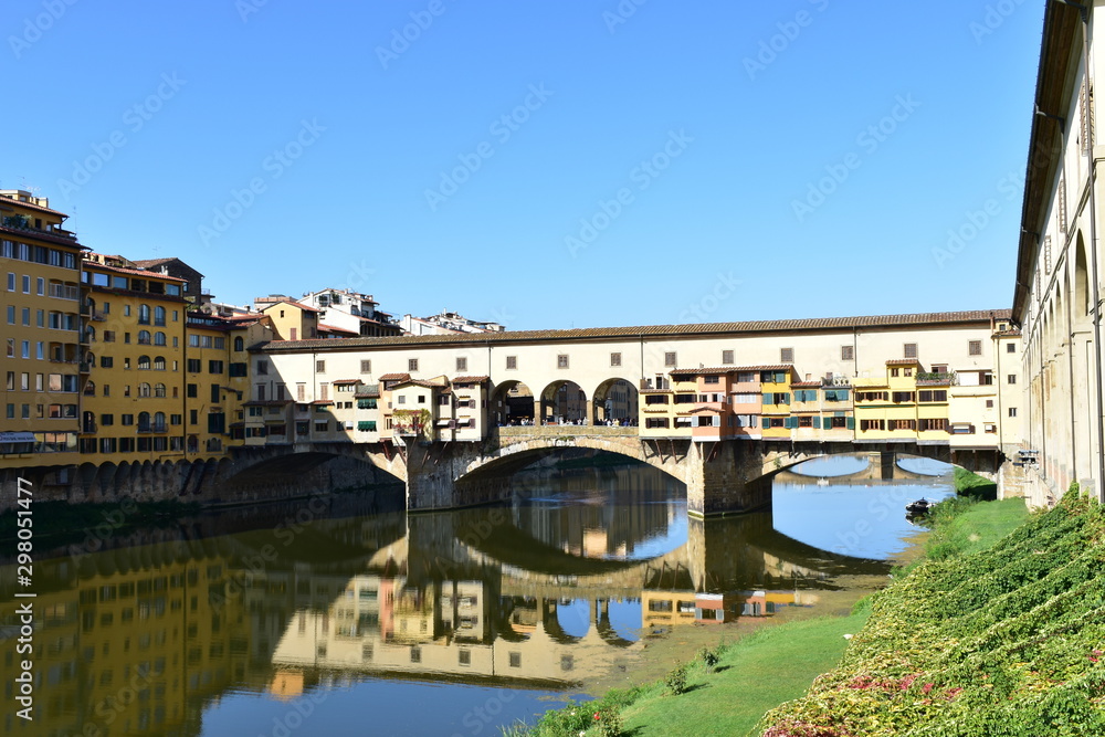 Ponte Vecchio and Arno River with blue sky. Florence, Italy.
