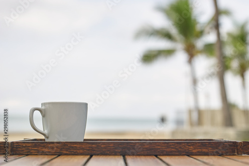 takeaway cup of coffee on table at resorts background 