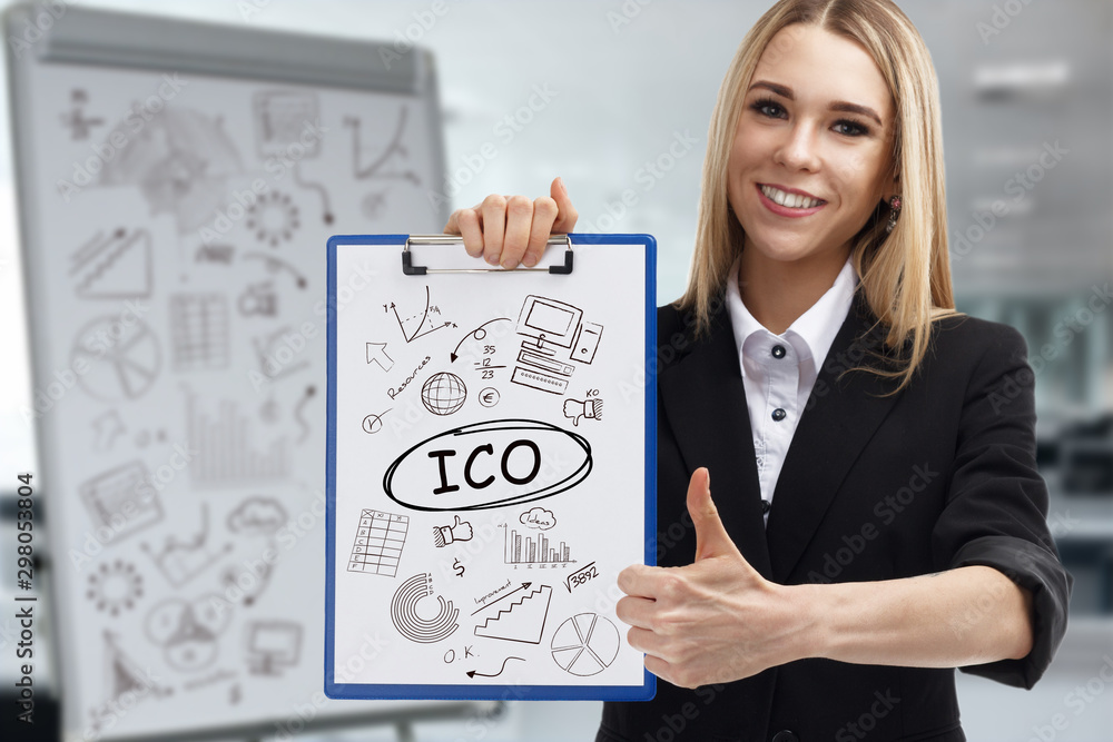 Business, technology, internet and network concept. Young businessman shows a key phrase: ICO Business, technology, internet and network concept. Young businessman shows a key phrase: ICO