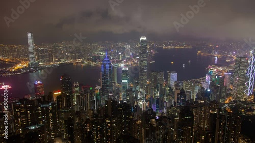 Wallpaper Mural Timelapse famous Hong Kong highrise buildings and towers with coloured illumination on wide harbor banks under cloudy sky at night zoom out Torontodigital.ca