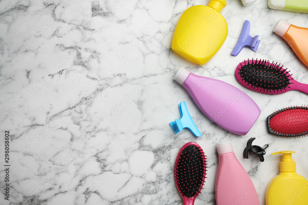 Flat lay composition with hair cosmetic products and tools on marble background. Space for text Flat lay composition with hair cosmetic products and tools on marble background. Space for text