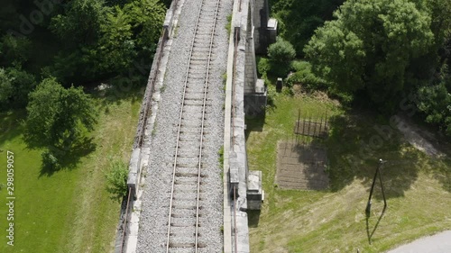 Revealing aerial shot directly above railway viaduct bridge in Ravne na koroškem, Slovenia photo