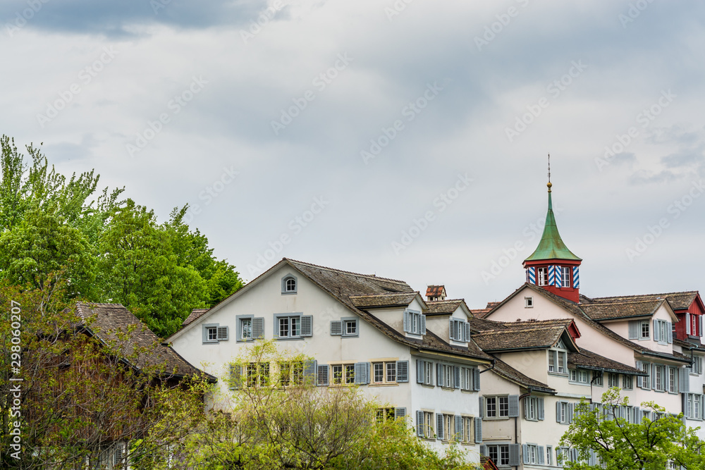 View of the historic center of Zurich at the bank of Limmat River, with beautiful house rooftops in spring, view form Lindenhof hill.
