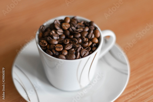 white cup full of coffee beans