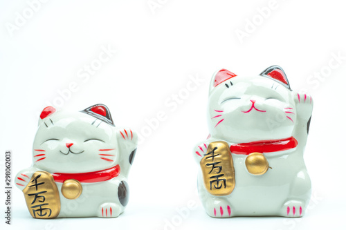Lucky cat statue for Japanese isolated on a white background, Holds a gold medal in Japanese that translates into prosperity and good fortune.