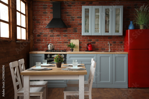 Stylish kitchen interior with dining table and chairs