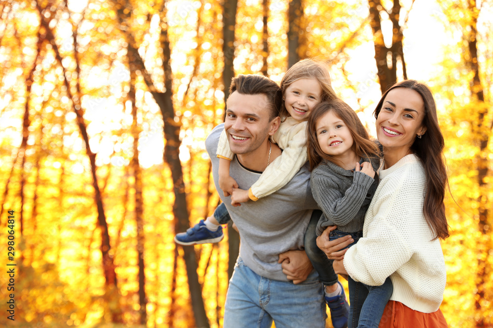 Happy family with little daughters in park. Autumn walk Happy family with little daughters in park. Autumn walk