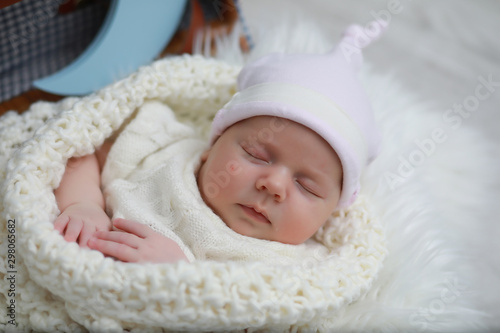 Baby newborn sleeping wrapped up in a blanket