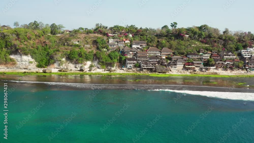 The surf spot of Bingin at the cliffs of Uluwatu during a sunny day. Aerial shot. The surf spot of Bingin at the cliffs of Uluwatu during a sunny day. Aerial shot.
