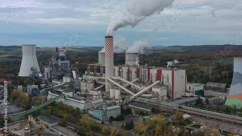 Aerial view of huge coal thermal power plant, steaming chimney and cooling towers - landscape panorama of Poland from above, Europe photo