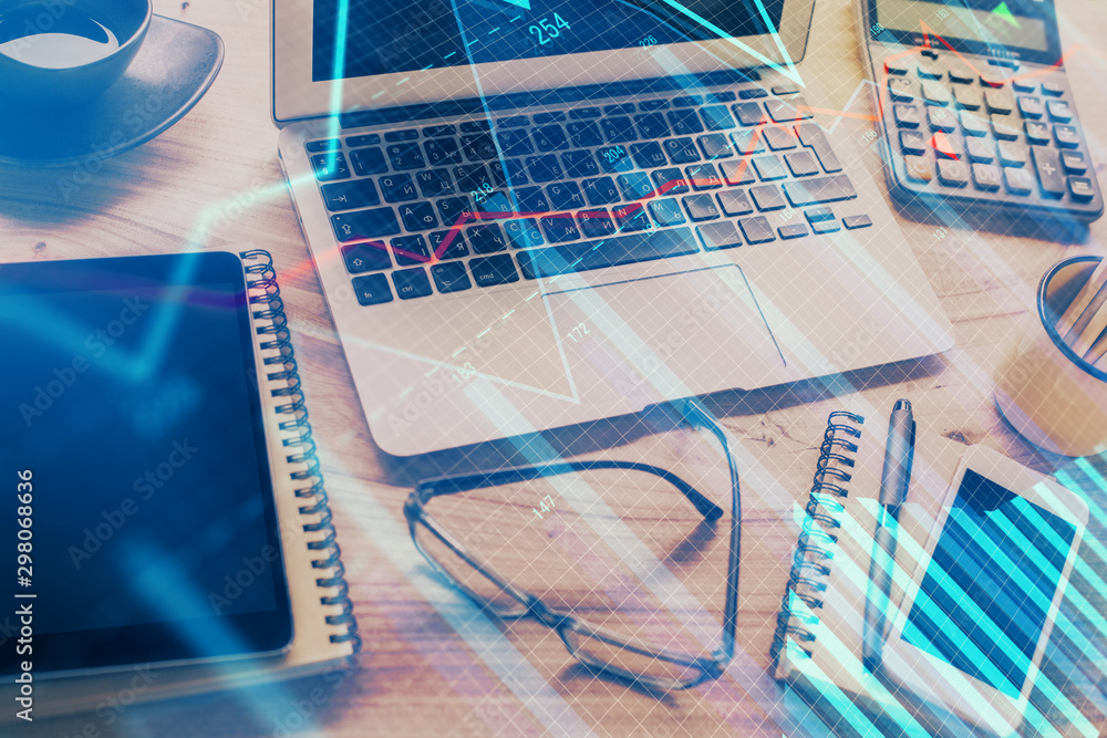Double exposure of chart and financial info and work space with computer background. Concept of international online trading. Double exposure of chart and financial info and work space with computer background. Concept of international online trading.