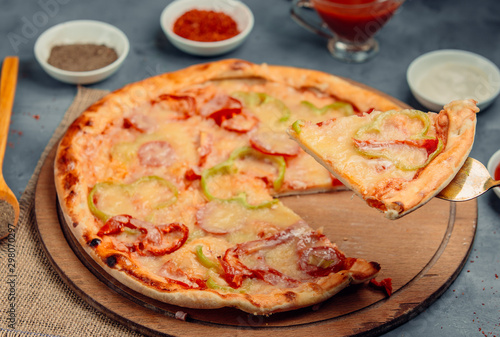 pizza with bell pepper on wooden board