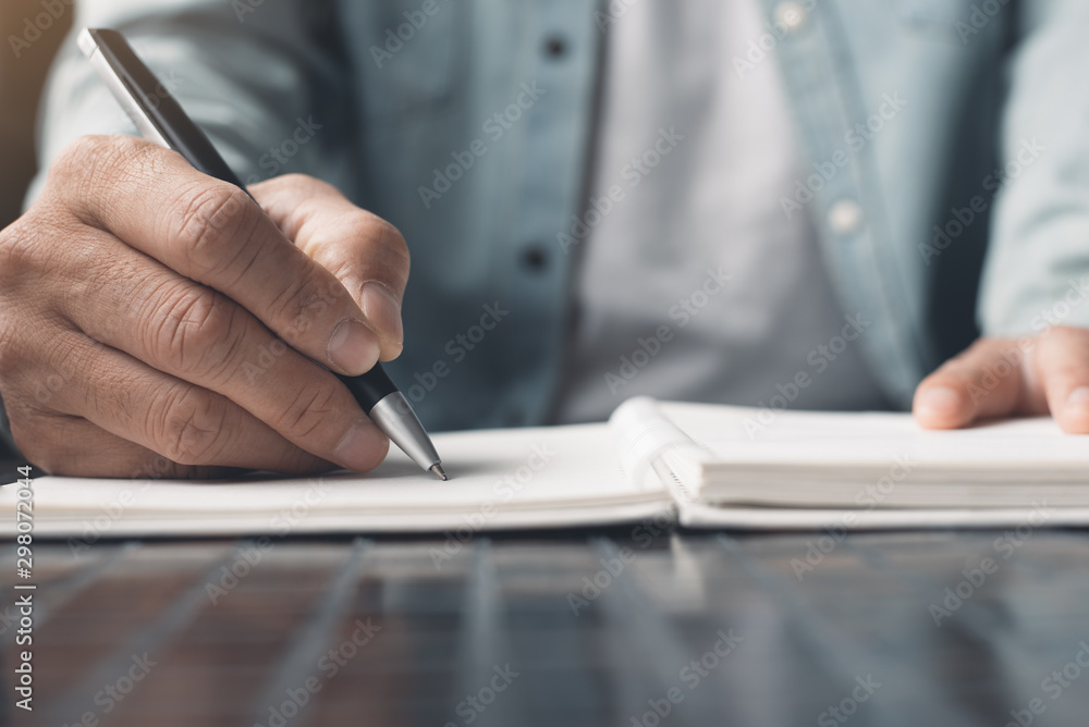 Man writing on notebook Man writing on notebook