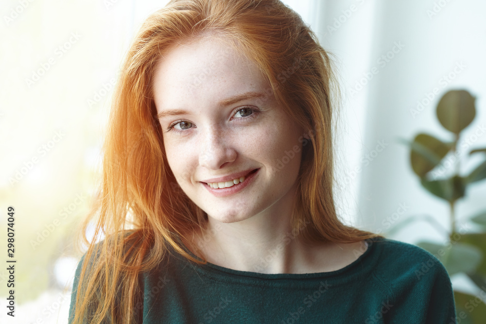 candid indoor portrait of pretty smiling red haired young girl, sunny morning light candid indoor portrait of pretty smiling red haired young girl, sunny morning light