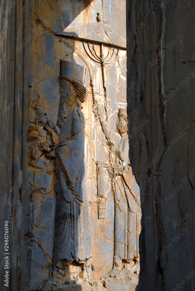 Two guys with umbrella. Ancient relief. Persepolis (6th-4th century BC), capital of the Achaemenid Empire (World Heritage Site since 1979), Iran.