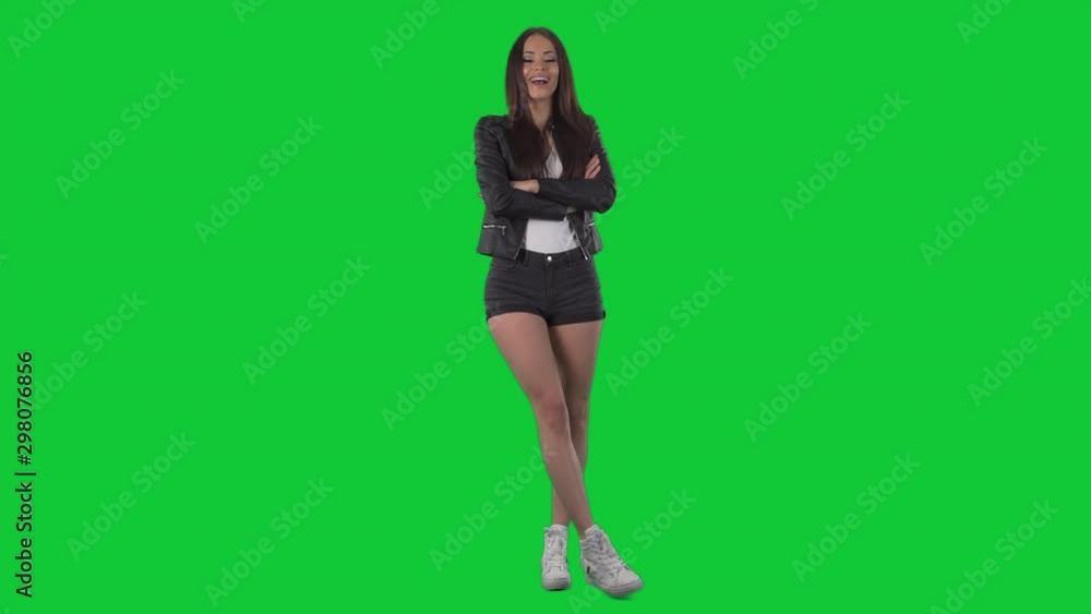 Happy confident modern young woman posing with crossed arms and smiling. Full body isolated on green screen chroma key background Happy confident modern young woman posing with crossed arms and smiling. Full body isolated on green screen chroma key background