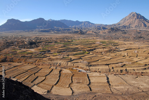 Terrace fields and ruins of medieval adobe mud-brick Kharanaq town. Iran. photo