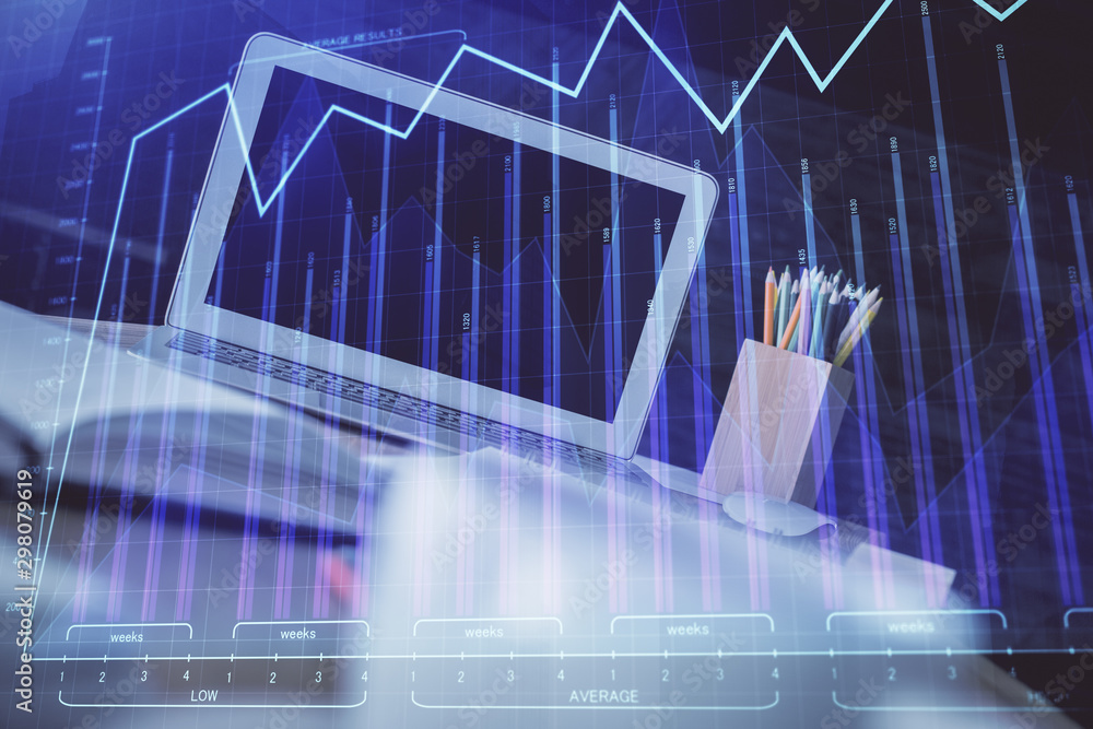 Stock market chart hologram drawn on personal computer background. Multi exposure. Concept of investment. Stock market chart hologram drawn on personal computer background. Multi exposure. Concept of investment.
