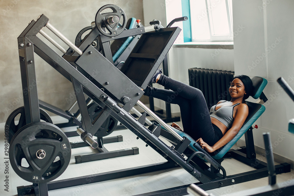 Beautiful black girl in the gym. A woman in a gray top Beautiful black girl in the gym. A woman in a gray top