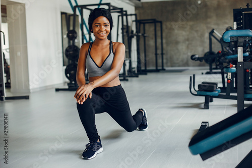 Beautiful black girl in the gym. A woman in a gray top
