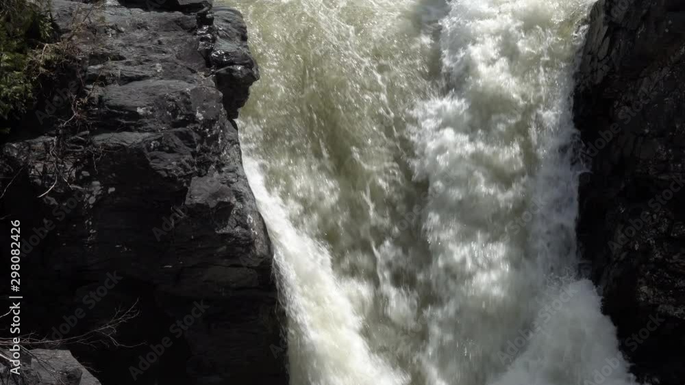 View of a waterfall through the rocks in Gaspesie, Quebec, Canada. View of a waterfall through the rocks in Gaspesie, Quebec, Canada.