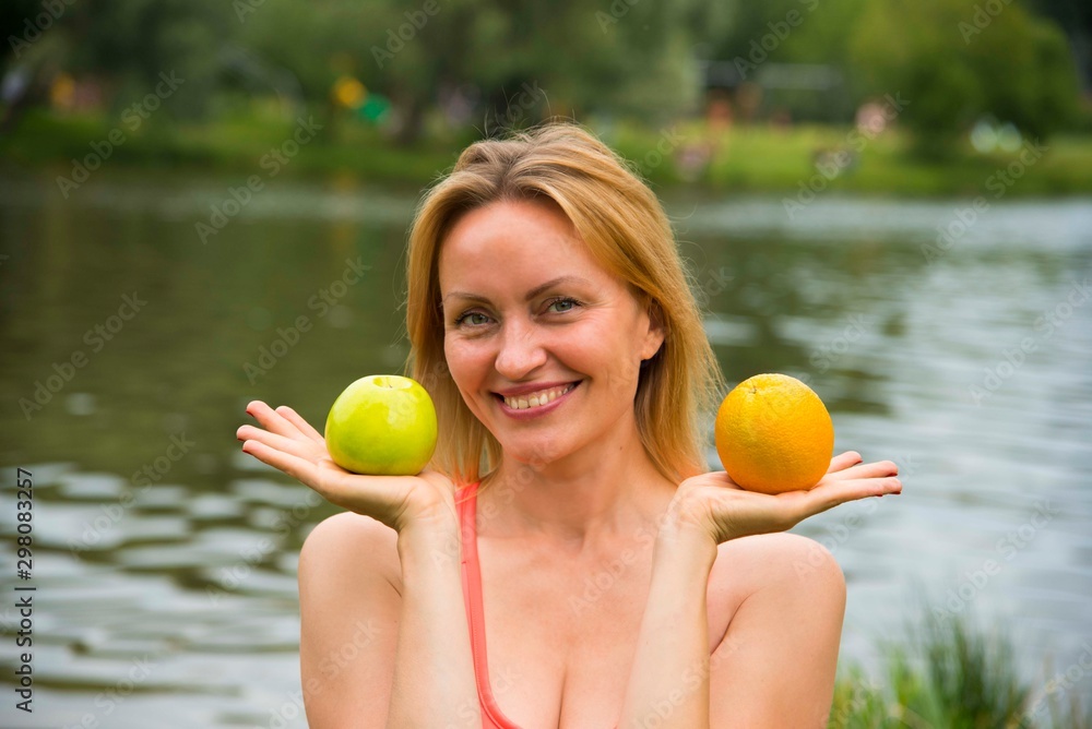 yellow orange and green Apple on women's hands on summer day yellow orange and green Apple on women's hands on summer day
