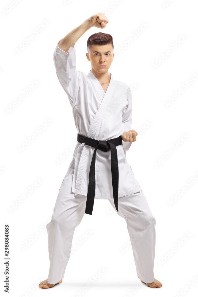 Boy in kimono exercising block technique in martial arts Boy in kimono exercising block technique in martial arts