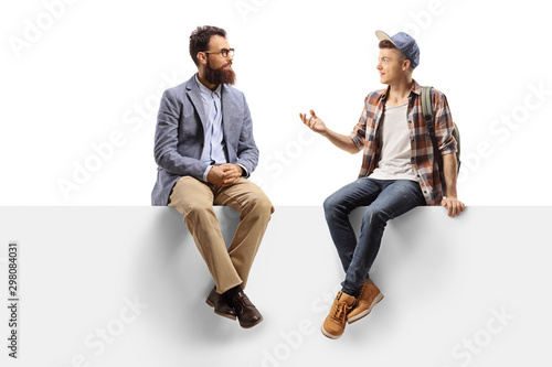 Bearded man and a teenage male student sitting on a panel and talking © Ljupco Smokovski