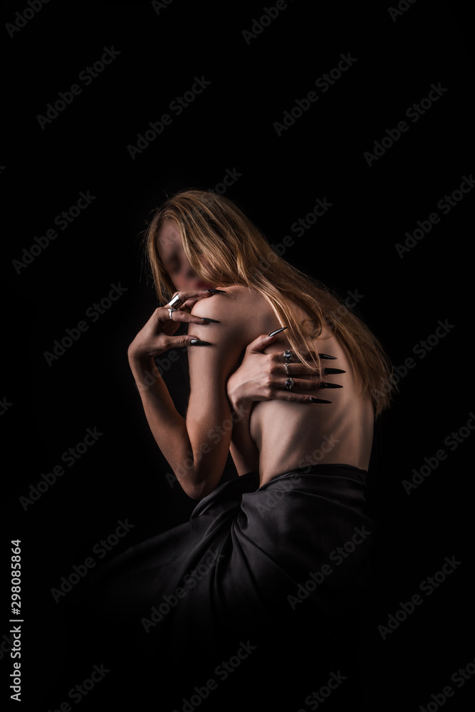 A girl with a bare back, severe thinness and protruding ribs. The concept of anorexia and bulimia, a disease of thin people. The struggle of the evil spirit in a girl, suffering and poverty. A girl with a bare back, severe thinness and protruding ribs. The concept of anorexia and bulimia, a disease of thin people. The struggle of the evil spirit in a girl, suffering and poverty.