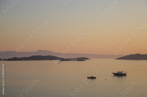 Beautiful tranquil pastel colored sunset over the sea horizon  © triocean