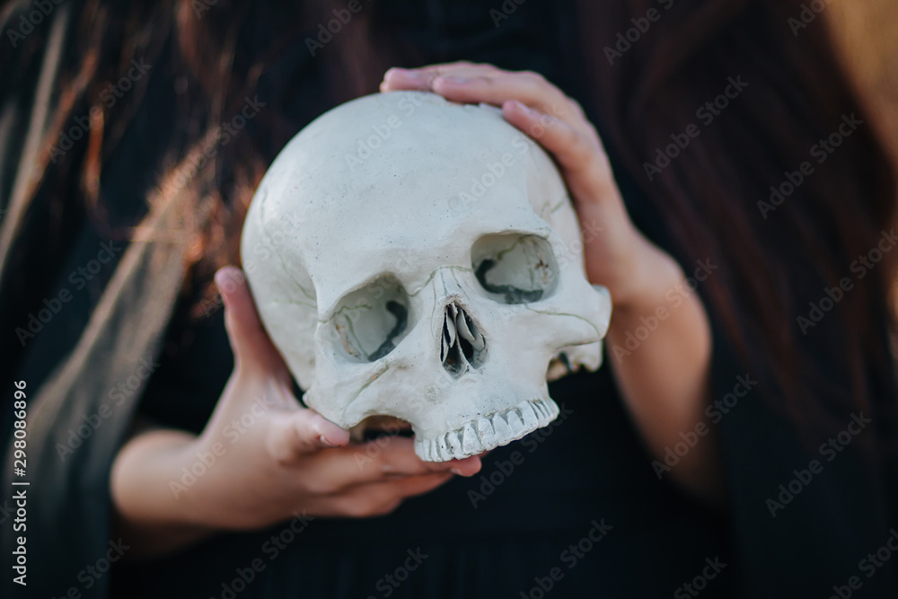 A young, beautiful girl with pale skin and black lips in the form of a witch for Halloween. A model with clean skin. A young, beautiful girl with pale skin and black lips in the form of a witch for Halloween. A model with clean skin.