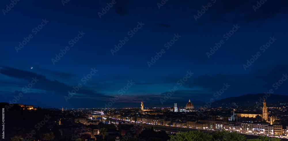 Florence by night - Panorama of Florence, Tuscany, Italy at dusk with the city center and landmarks: Lungarno, cathedral and Palazzo Vecchio (medieval city hall) and Boboli Gardens on the far left und